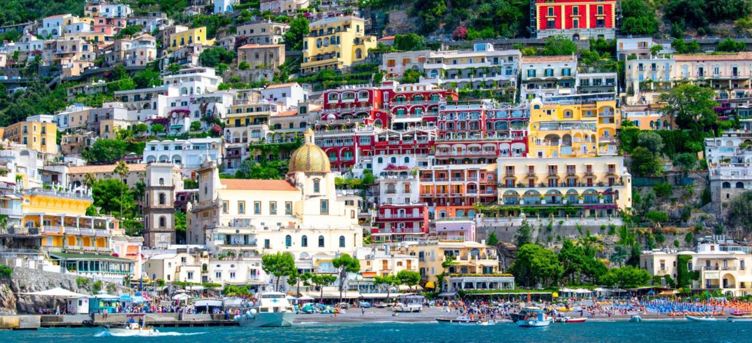 Colourful houses of Positano and the Church of Santa Maria Assunta seen from the sea