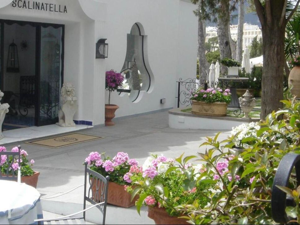 Entrance of a boutique hotel on Capri with flowers and garden terrace