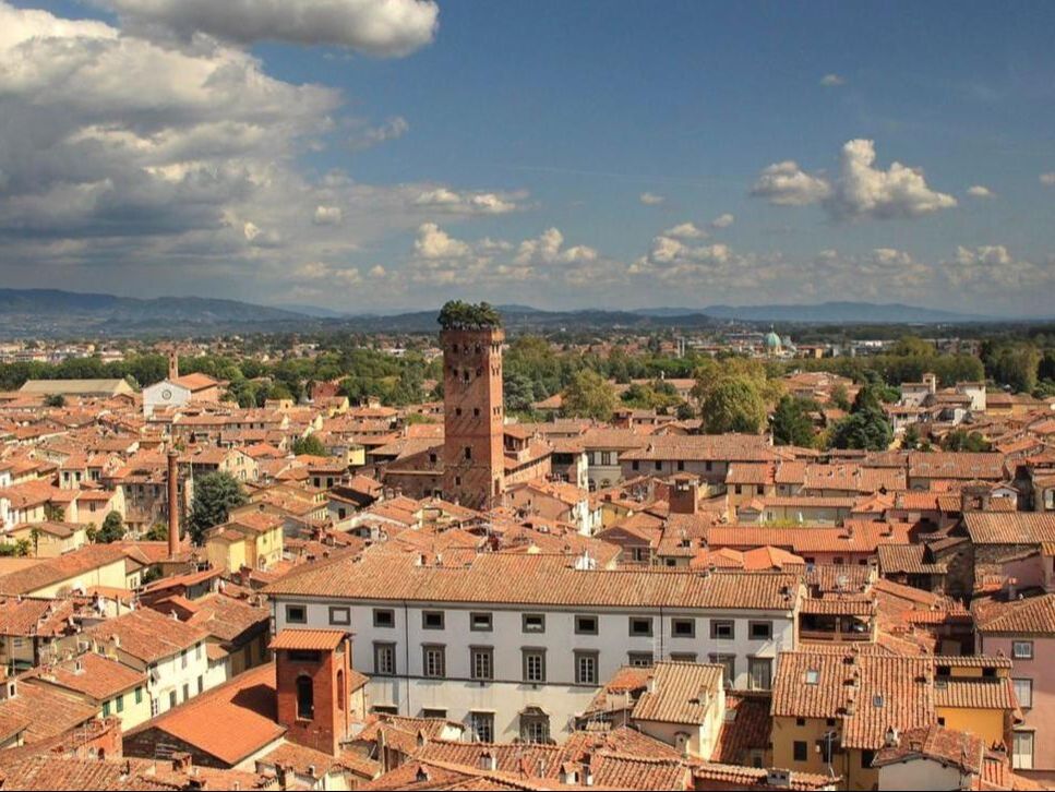 Rooftops of Lucca and the Guinigi Tower with the Tuscan hills beyond