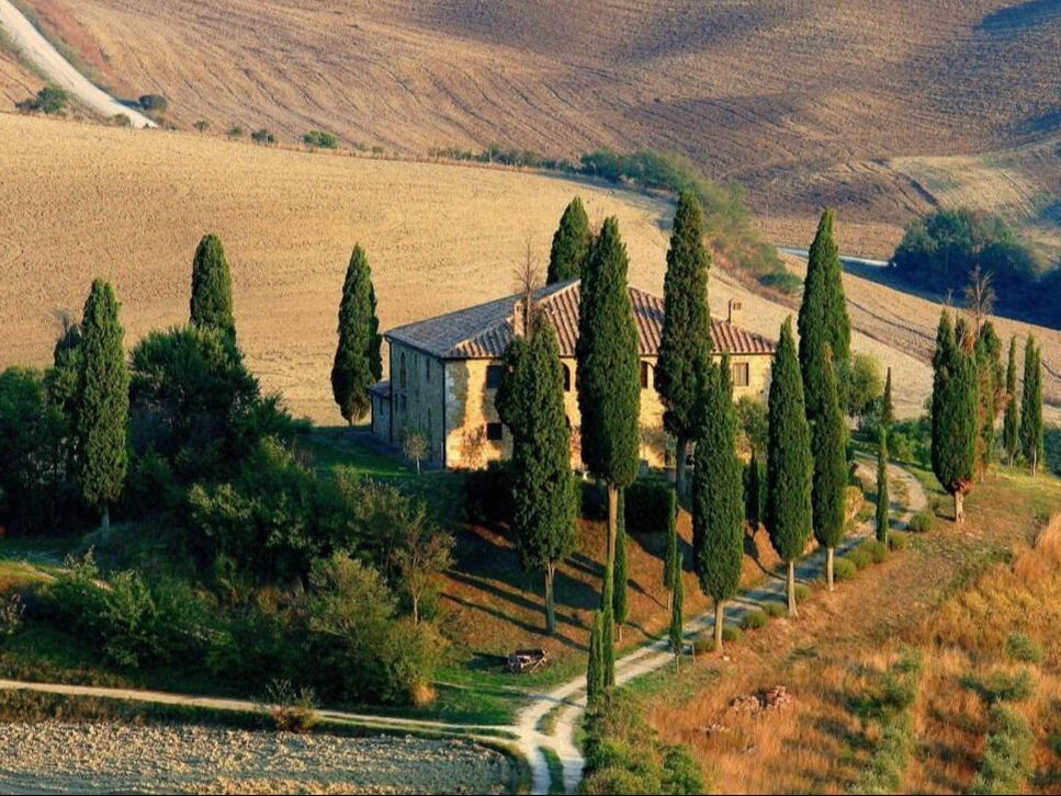 Tuscan farmhouse surrounded by cypress trees in Val d'Orcia, Tuscany