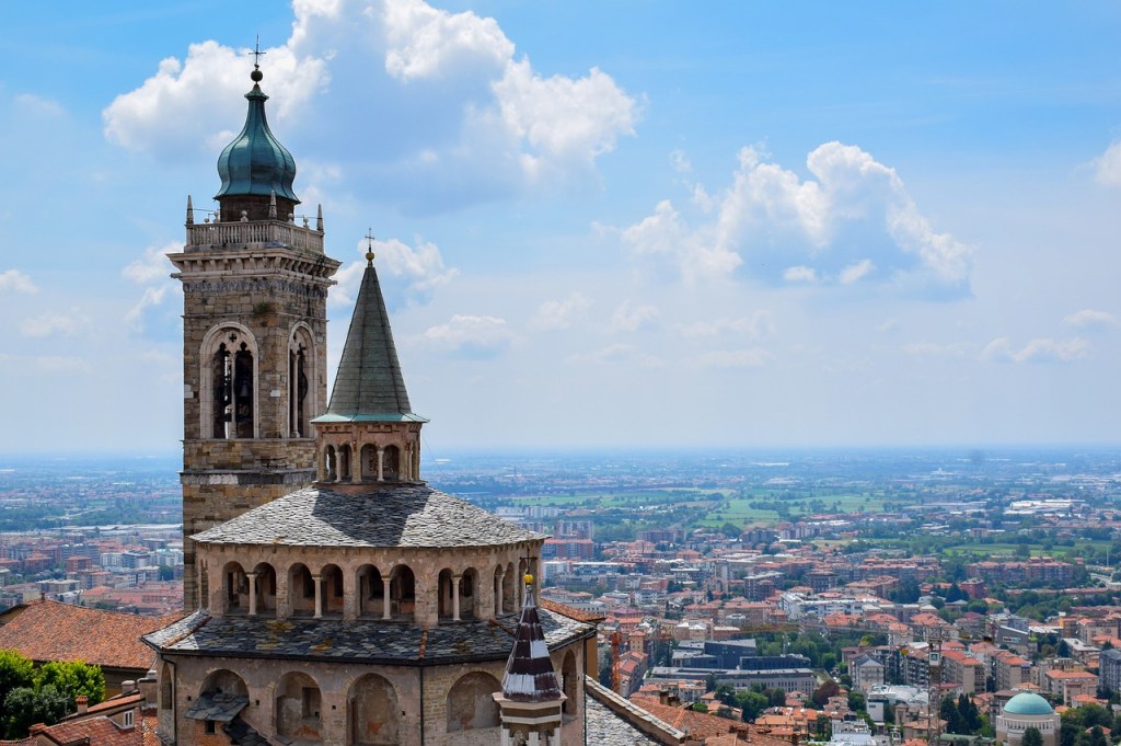 The bell tower of Bergamo’s Città Alta above the plain