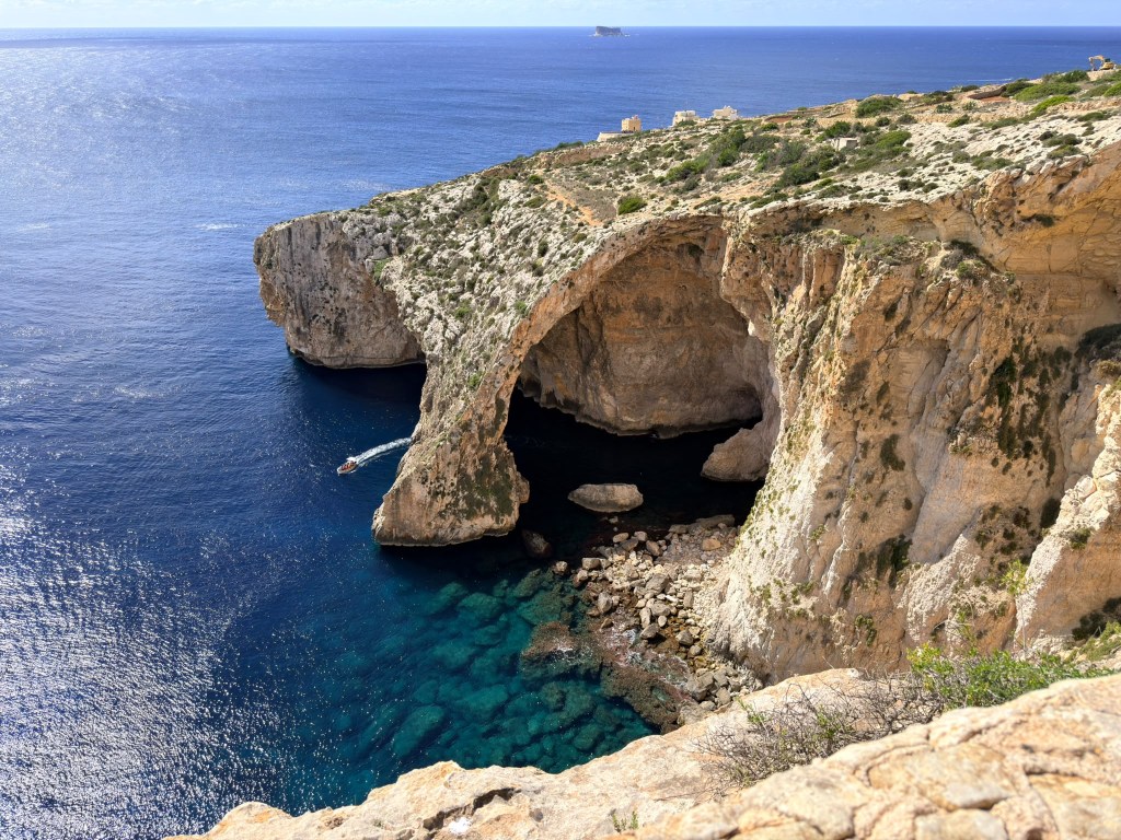 Limestone sea cliffs and crystal-clear water on the coast of Malta