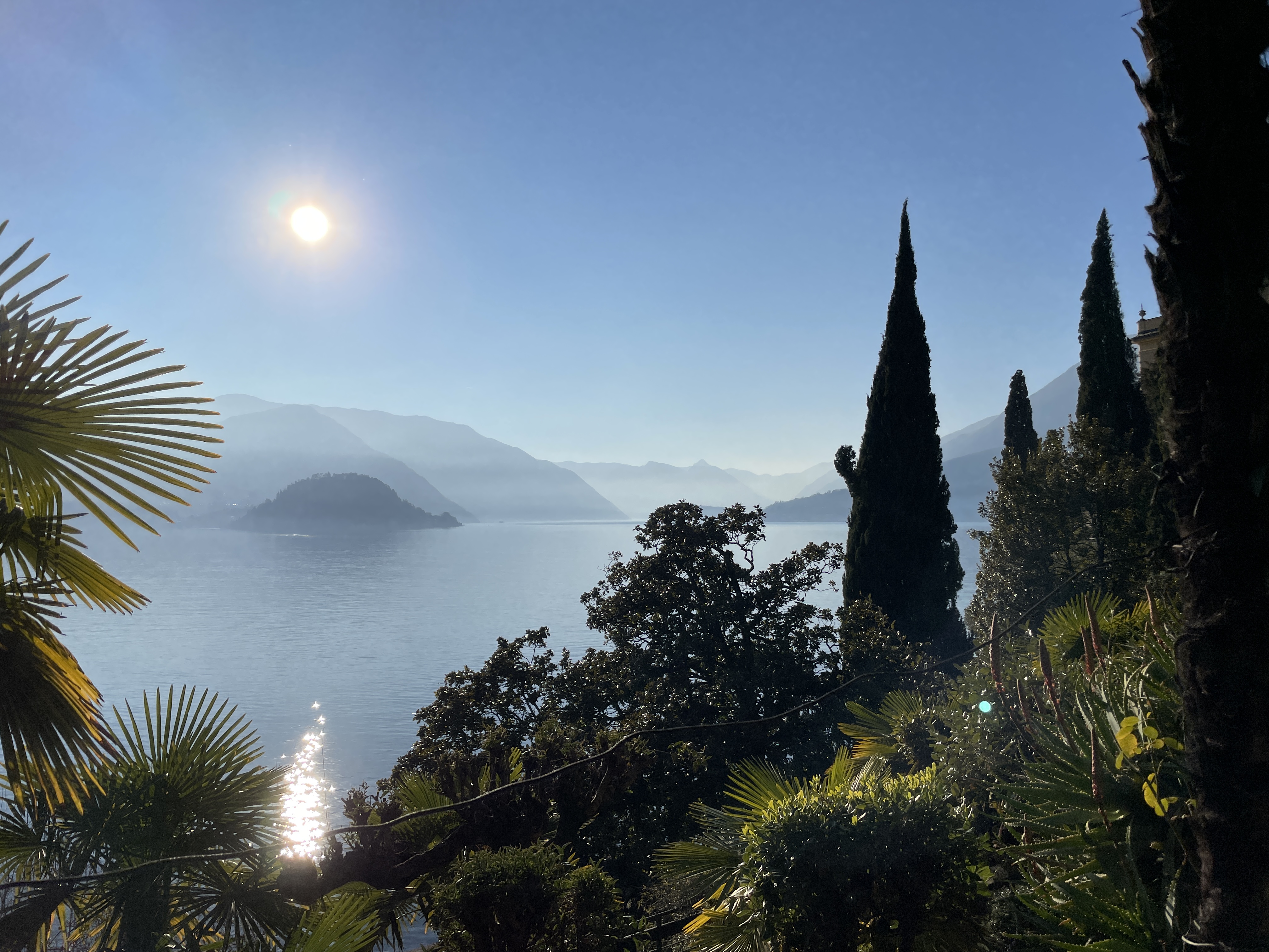 Cypress trees and Lake Como seen from the gardens of Villa Monastero in Varenna